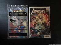 Front view of both comics in sleeves: Avengers FCBD #1 and Superman/Wonder Woman Kids’ Meal