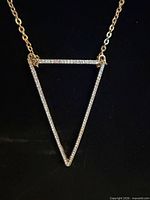 Close-up of triangle pendant with CZ stones