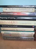 Stack of ten Krishnamurti-related books showing titles and spine wear
