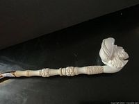 Full length view of meerschaum pipe showing stem and carved bowl