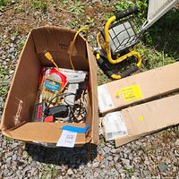 Overview of box contents, work light, two boxed under-cabinet fixtures