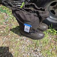 Full view of both black snow boots standing upright