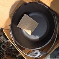 Interior of cast iron Dutch oven with instruction manual visible