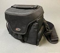 Exterior view of black Lowepro shoulder camera bag with strap and flap
