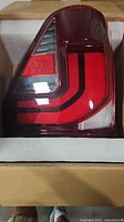 Tail light assembly in box showing lens and housing