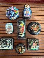 All eight assorted hand-painted boxes displayed