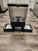Front view showing feeder with dual stainless steel bowls