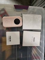 Overview of label maker with two tape boxes and two paper packs