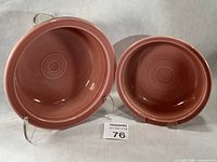 Large and small rose Fiesta bowls on stands