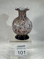 Front view of Sasaki cased glass bud vase showing pattern and black base