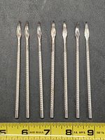 All seven cuticle pushers lined up with measuring tape