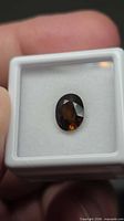 Front view of oval fire orange tourmaline in gem box