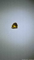 Pear-cut golden yellow sapphire on neutral background