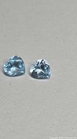Front view of both heart-cut blue topaz stones