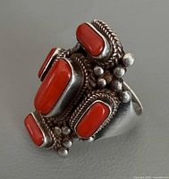 Oblique view showing side rope and bead work plus five coral cabochons