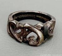 Front view showing double-heart design and patina