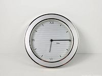 Front view of Deko chrome wall clock showing entire dial