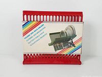 Dish rack folded with box front showing product image and rainbow stripes