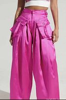 Model image showing front view of the bright fuchsia parachute cargo pants worn, highlighting color, high waist, wide leg, and cargo pockets