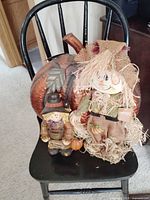 All three decorative items grouped on chair