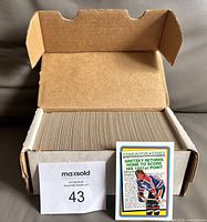 Cardboard two-row box filled with hockey cards, loose Gretzky tribute card displayed in front
