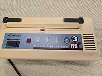 Front view showing Achiever PPS2 label, control panel and slot