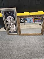 Both framed pieces side by side on floor