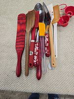Top view of grouped utensils showing wood, stainless and silicone pieces