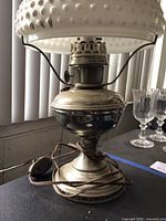 Lamp base showing nickel finish and electric cord