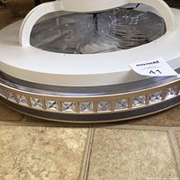 Side view showing crystal-accented rim and white diffuser