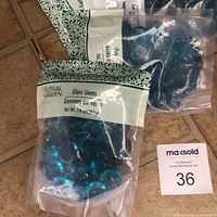 Front of sealed Floral Garden Glass Gems bag showing product name and color