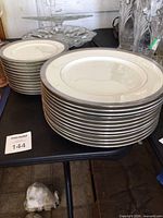 Two stacks of Mikasa plates, larger and smaller sizes, total 24