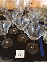 Group of vintage etched stemmed glasses on tray