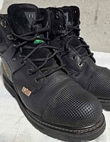 Oblique view showing both Workload boots, laces, steel toe, and leather condition