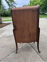 Front view of cabinet closed, showing bombe sides, cabriole legs and overall finish condition