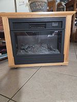Front view of oak veneer electric fireplace heater