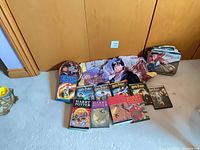 Overview of all items: books, DVDs, lunchbox, tin, blanket