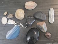 Top view of ten assorted stones including agate slice pendant, polished and rough pieces