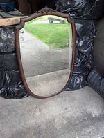Front view of detached beveled mirror in wood frame