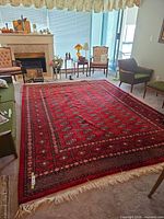Full view of red Bokhara area rug in living room setting