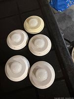 Five puck lights arranged on table
