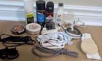 All shoe-care items, sprays, tins, laces and applicator laid out