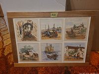 Full view of framed panel showing six illustrated ceramic tiles in wood frame