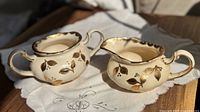 Both porcelain pieces side by side showing motif and form