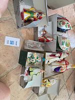 Group of all ornaments in boxes showing designs and colors