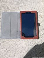 Front view of Amazon Fire tablet in brown folio case, screen visible