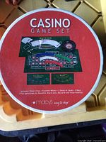 lid of round casino game set box showing included components list