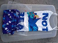 Full view of tank top and shorts laid flat, showing graphics and colors