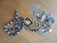 Full view of all jewelry items spread on wood surface