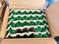 Open carton showing rows of green-endcap Philips Alto tubes